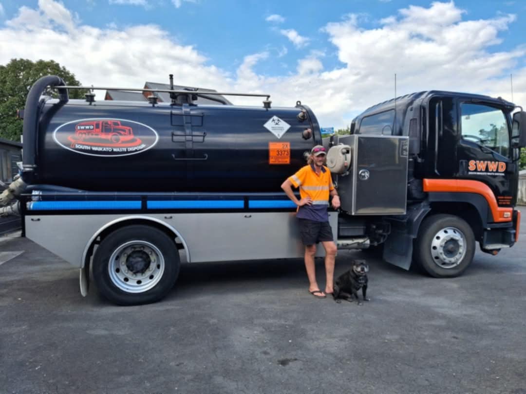 Liquid waste disposal truck in a rural setting